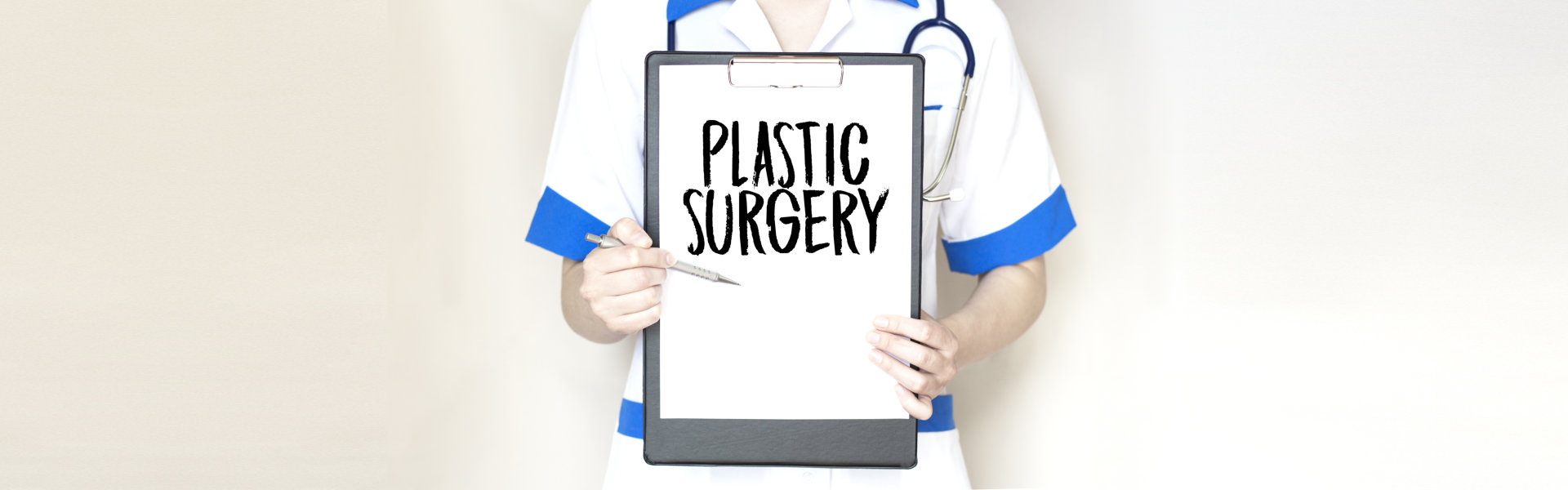 Doctor holding paper plate with text Plastic Surgery