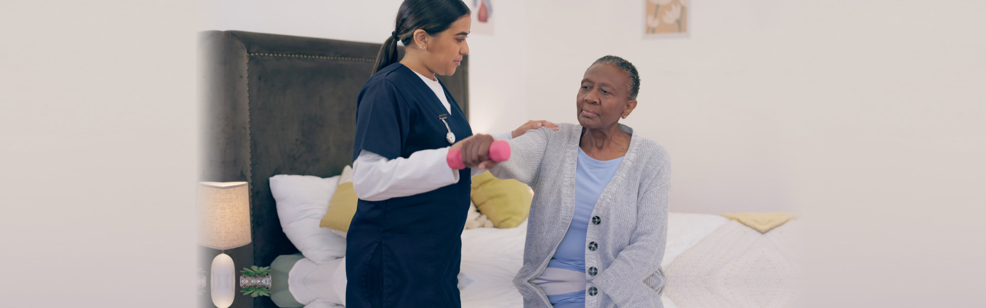 healthcare worker assisting an elderly exercise