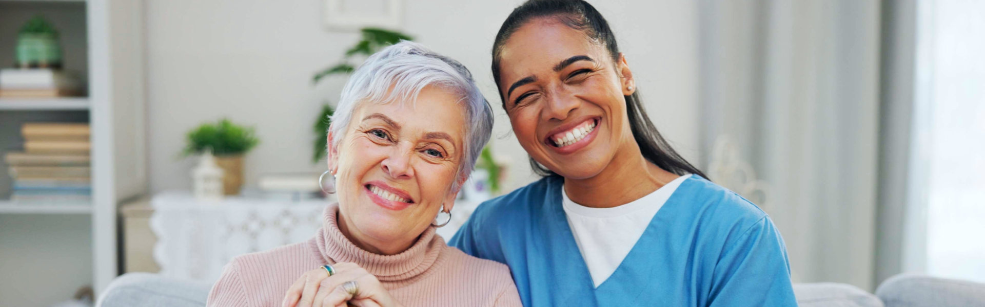a caretaker and an elder smiling while having a photo